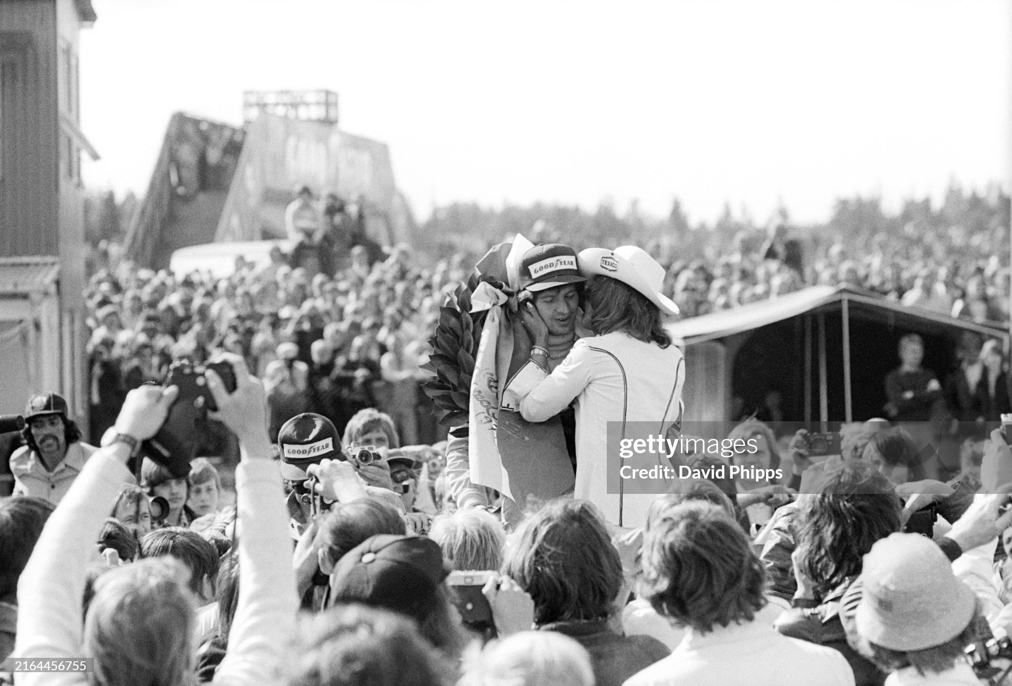 Jody Scheckter Tyrrell receives a congratulatory kiss from a Texaco grid girl on the podium after winning his first Grand Prix in Anderstorp on 09 June 1974.