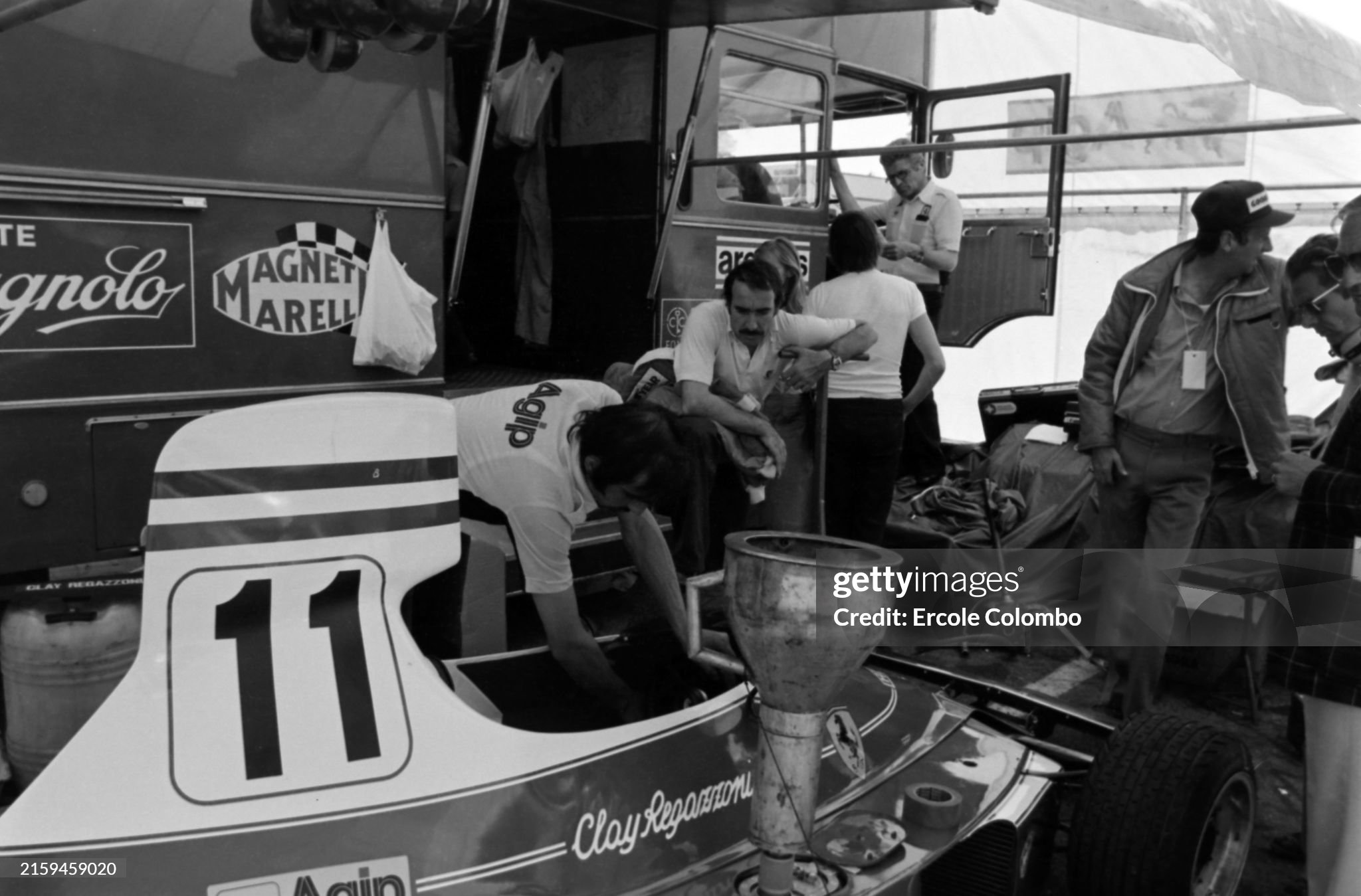 Clay Regazzoni observes as a mechanic works on his Ferrari 312T during the Swedish Grand Prix in Anderstorp on 08 June 1975. 