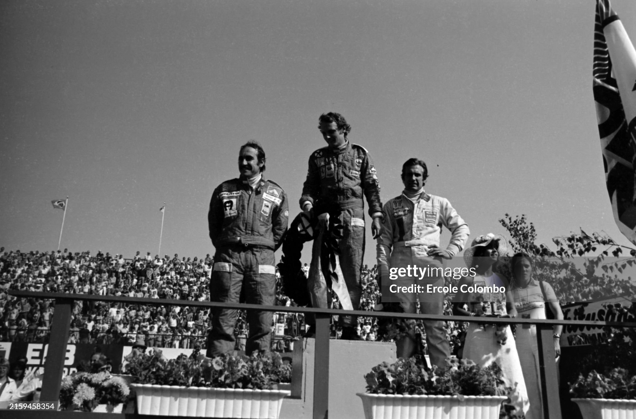Clay Regazzoni, 3rd position, Niki Lauda, 1st position, Carlos Reutemann, 2nd position, on the podium after the Swedish Grand Prix in Anderstorp on 08 June 1975. 