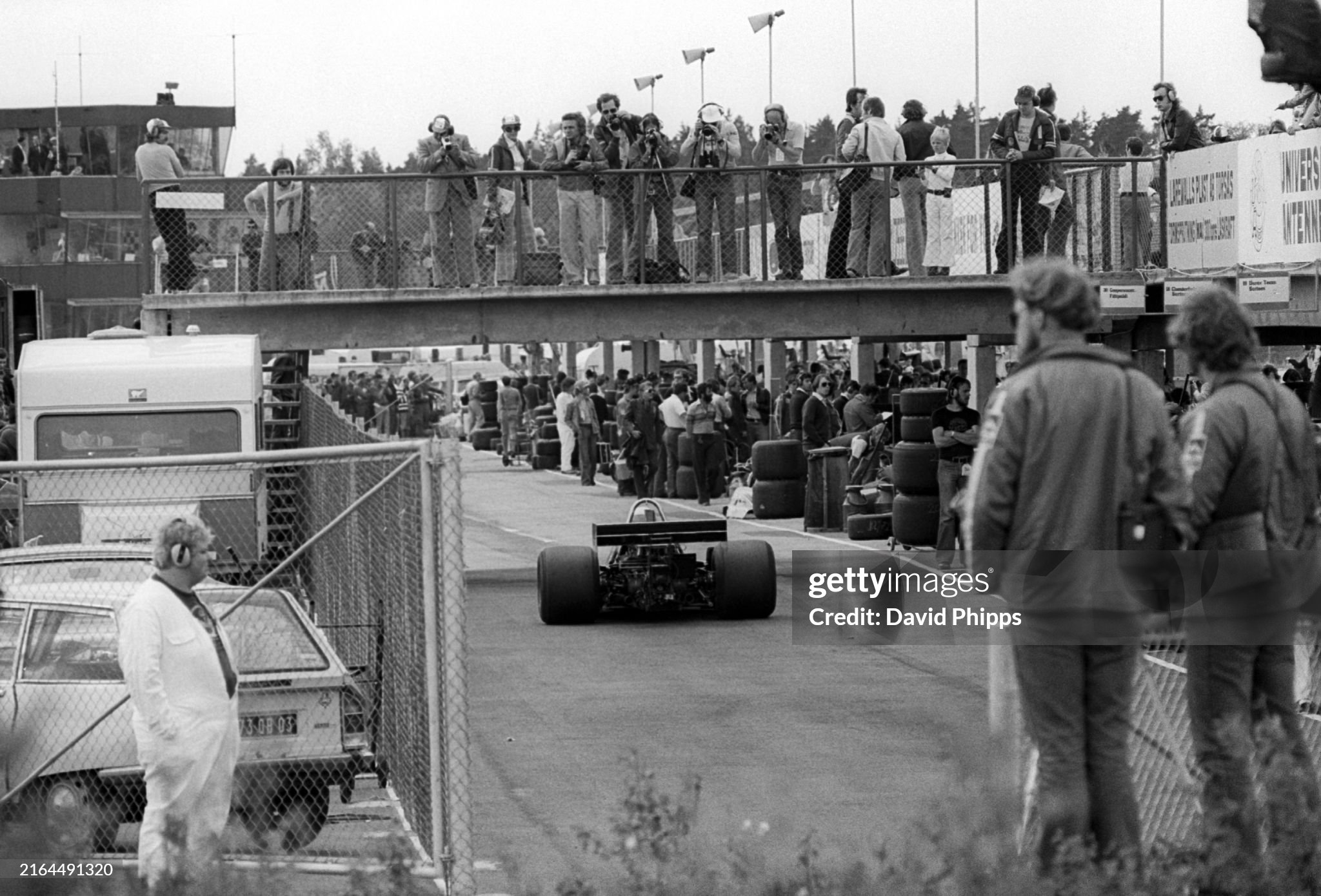 Photographers shoot from the bridge as race winner Jody Scheckter (RSA) Tyrrell P34 enters the distinctive pit lane during practice for the Grand Prix of Sweden in Anderstorp on 13 June 1976. 