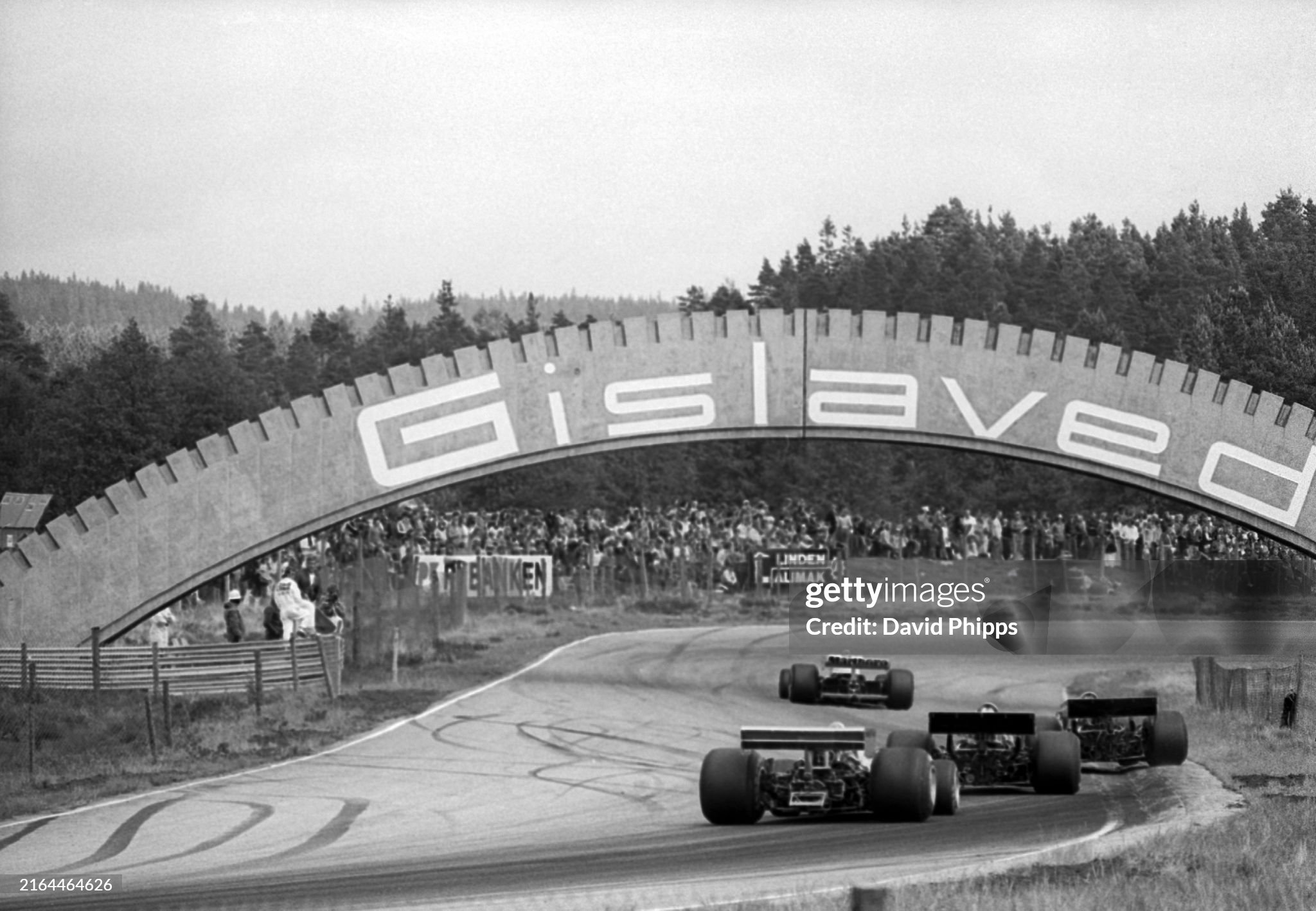 Competitors head under the Gislaved bridge on the circuit. Tyre company Gislaved were the race sponsors at the Grand Prix of Sweden in Anderstorp on 13 June 1976. 
