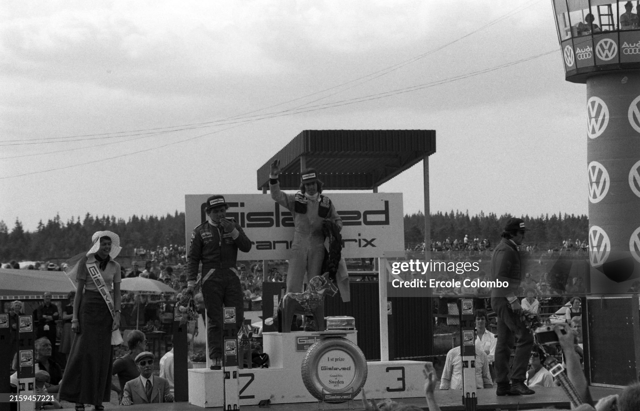 Jacques Laffite, 1st position, Jochen Mass, 2nd position and Carlos Reutemann, 3rd position, on the podium after the Swedish Grand Prix at Anderstorp Raceway on 19 June 1977. 