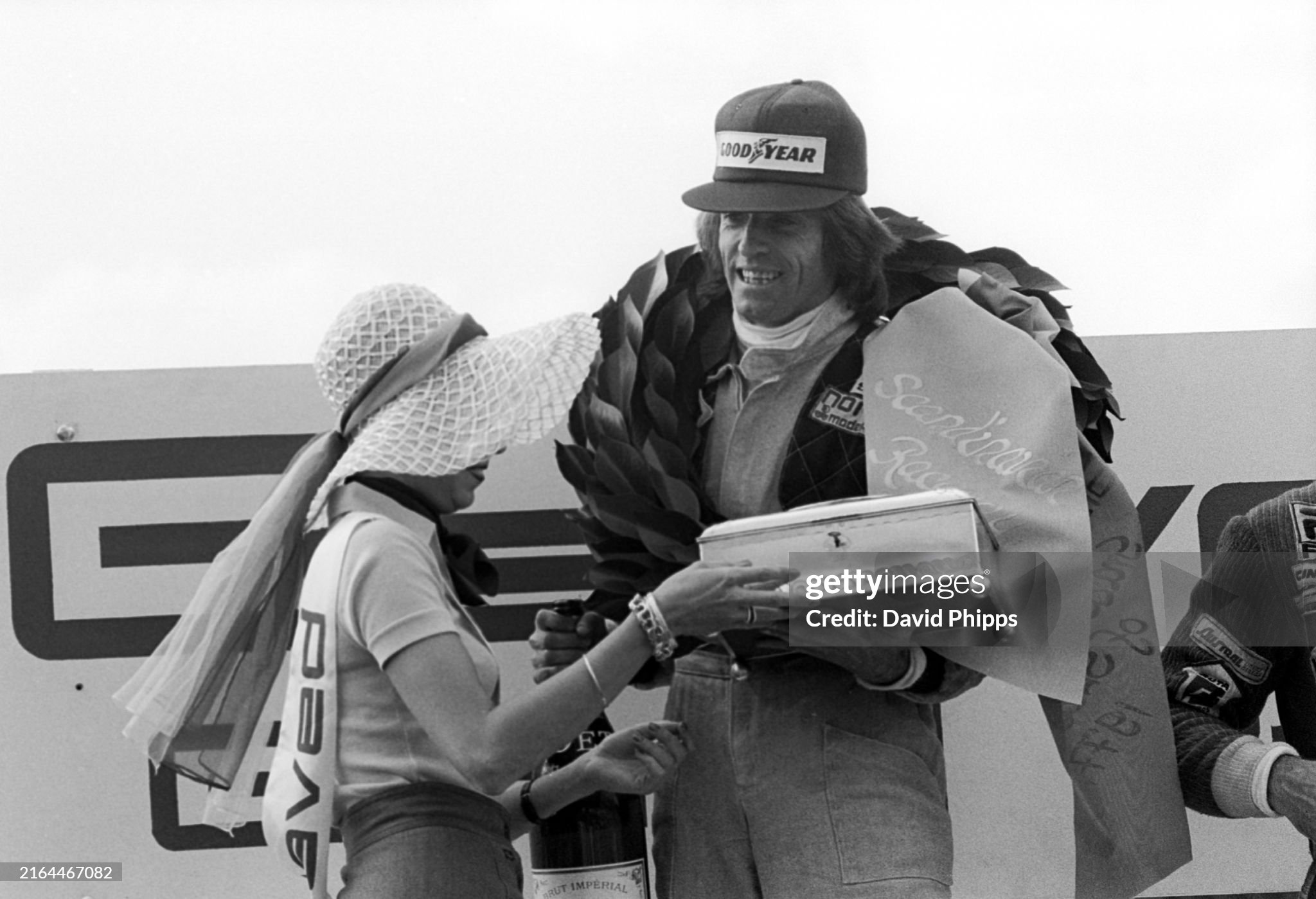 Jacques Laffite, Ligier, celebrates his and the team's first Grand Prix victory on the podium after the Swedish Grand Prix at Anderstorp Raceway on June 19 1977. 
