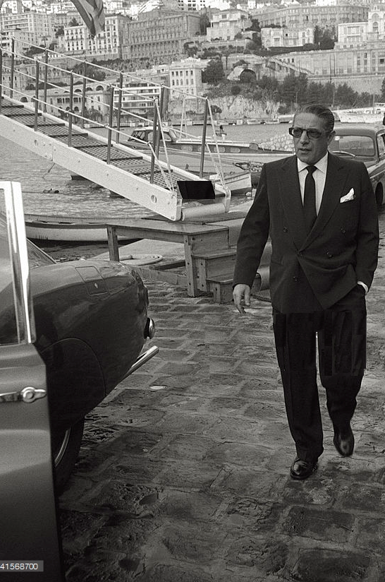 Aristotle Onassis just disembarked from his yacht 'Christina'.