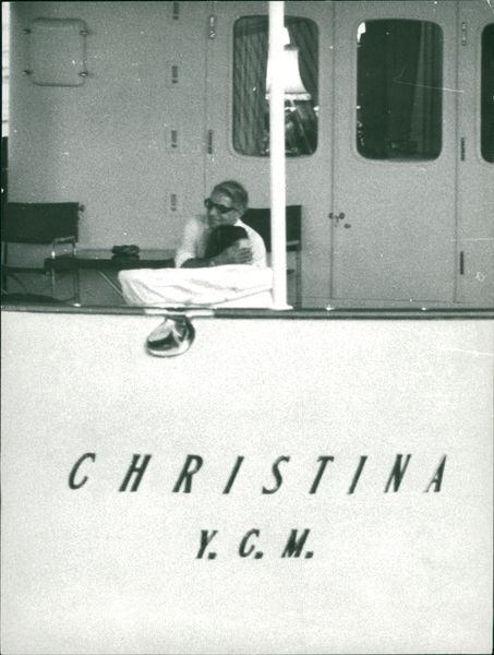 Aristotle Onassis embracing a woman aboard his ‘Christina’.