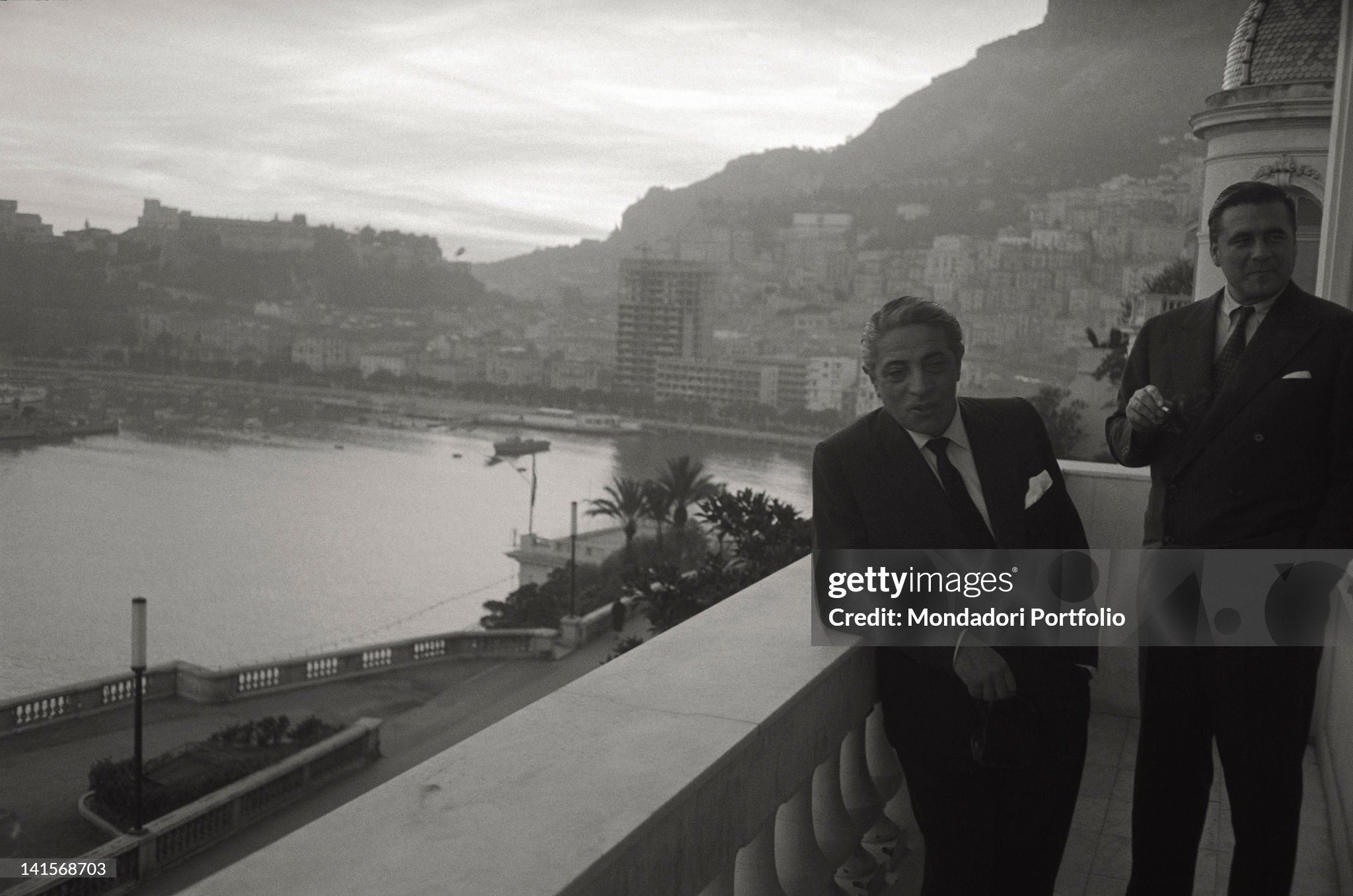 Aristotle Onassis, together with one of his collaborators, photographed on the terrace of a luxurious palace on the bay of Montecarlo.