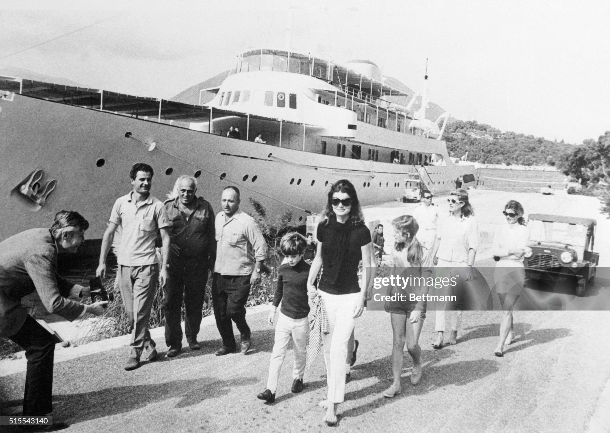 Jackie Kennedy Onassis walking beside the yacht Christina with her two children, Caroline and John F. Kennedy Jr., in Skorpios, Greece, on 19 October 1968. 