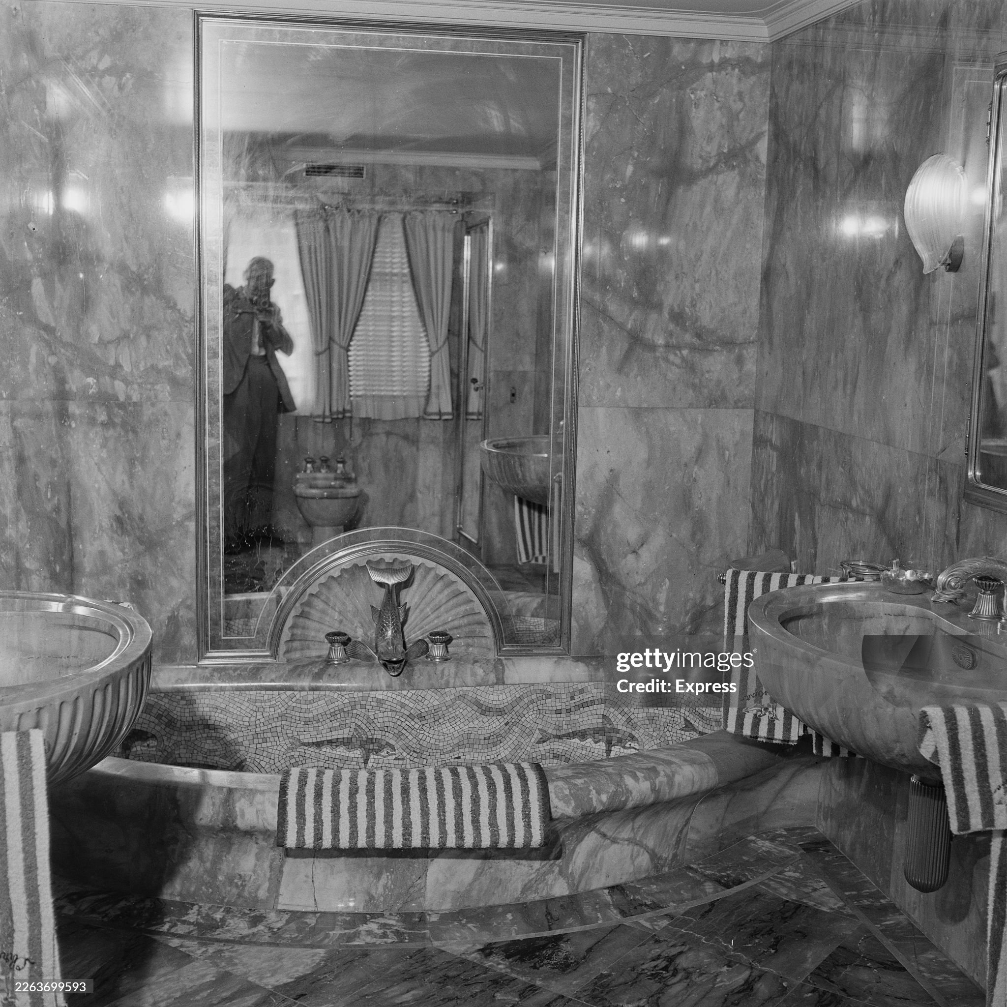 A mosaic-lined marble bathtub with a fish-shaped tap in a marble-lined bathroom on the 'Christina’ private motor yacht moored in Monte Carlo, Monaco, on 23 August 1955. The yacht belonged to Greek businessman Aristotle Onassis. 