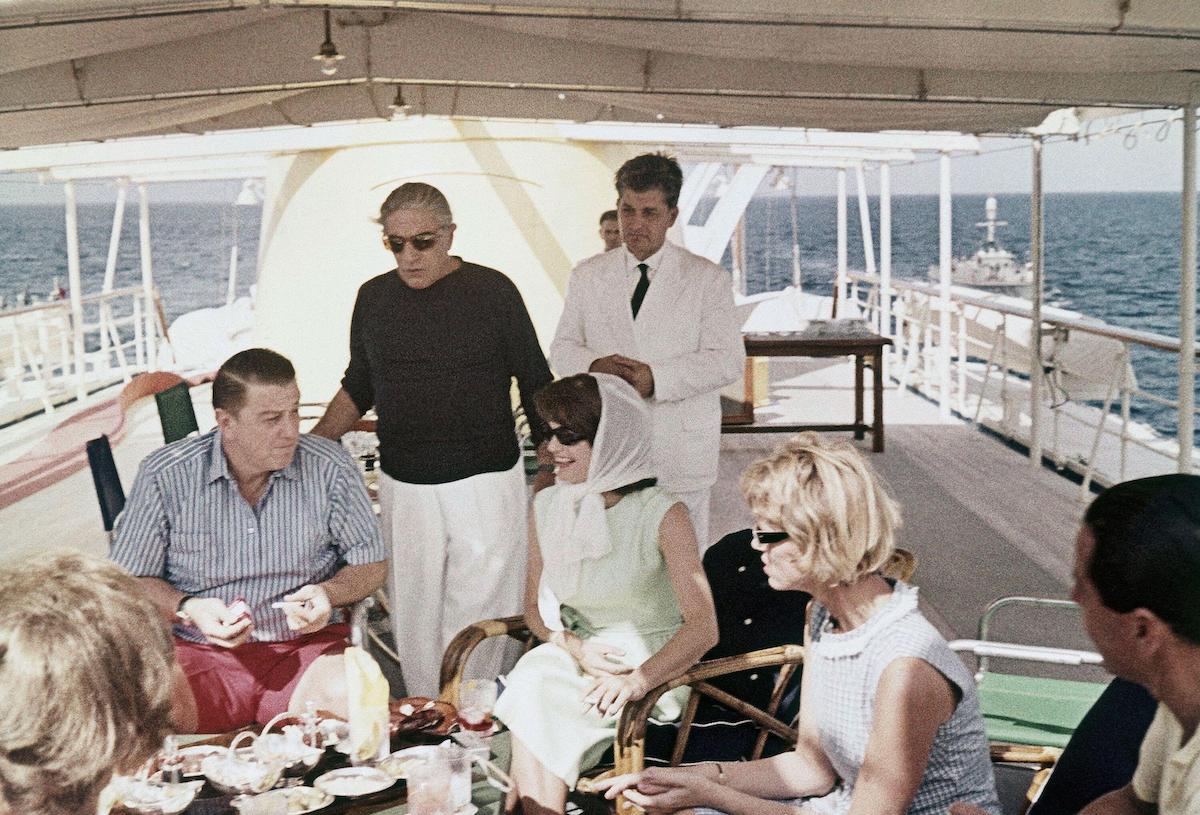 Aristotle Onassis on his yacht with Jackie Kennedy and some guests.