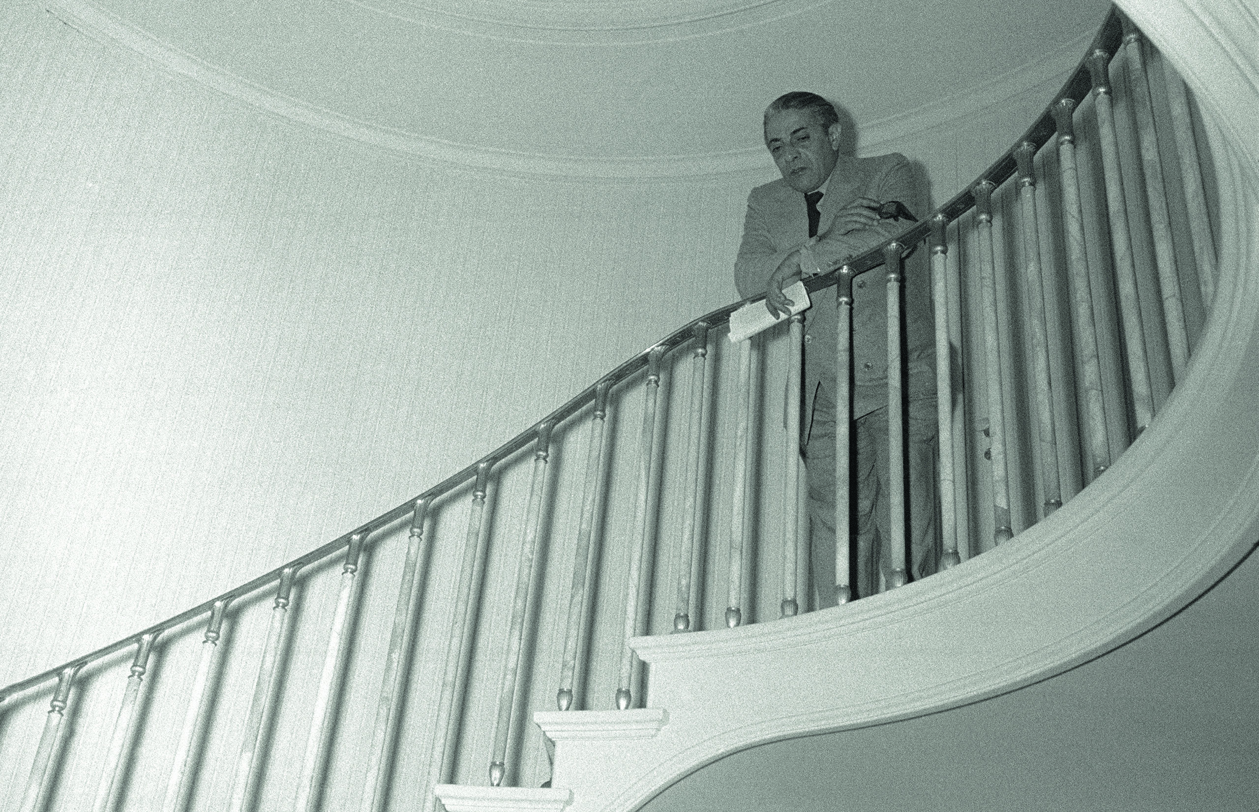 Aristotle Onassis at the top of the internal stairs of his yacht Christina.