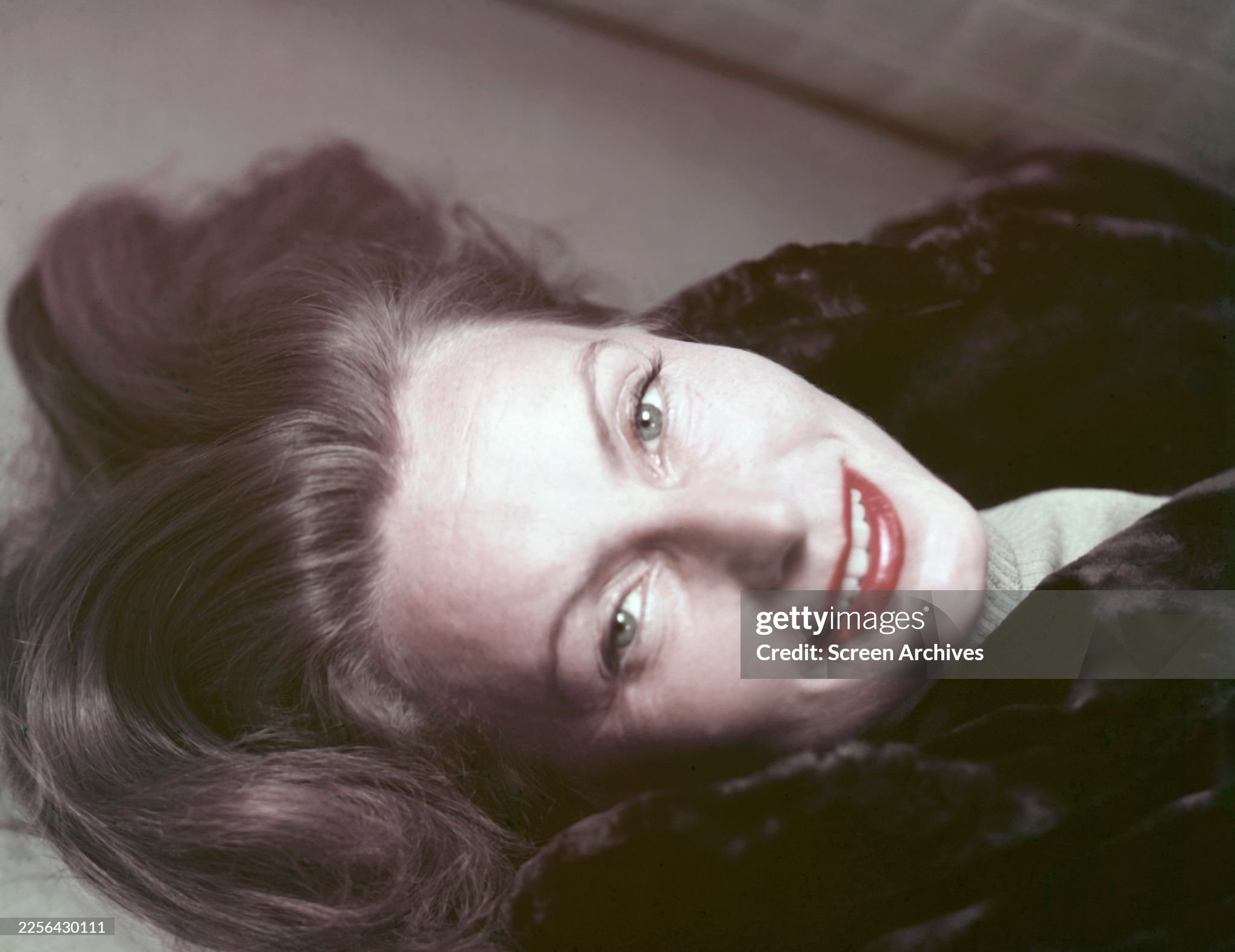 Greta Garbo smiling portrait wearing a fur coat circa 1950. 