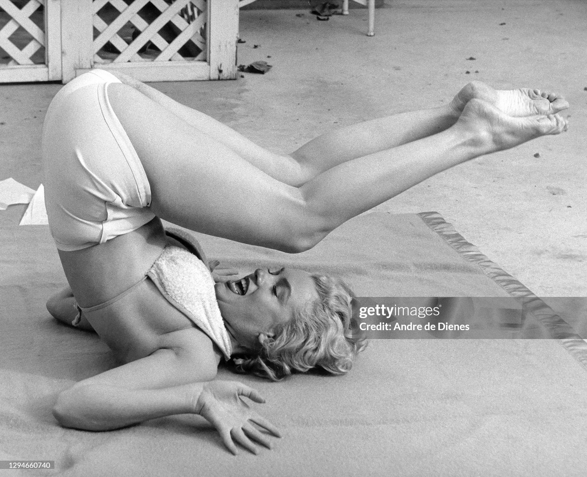 Marilyn Monroe performs stretching exercises outdoors at the Hotel Bel-Air, Los Angeles, California, in 1953. 