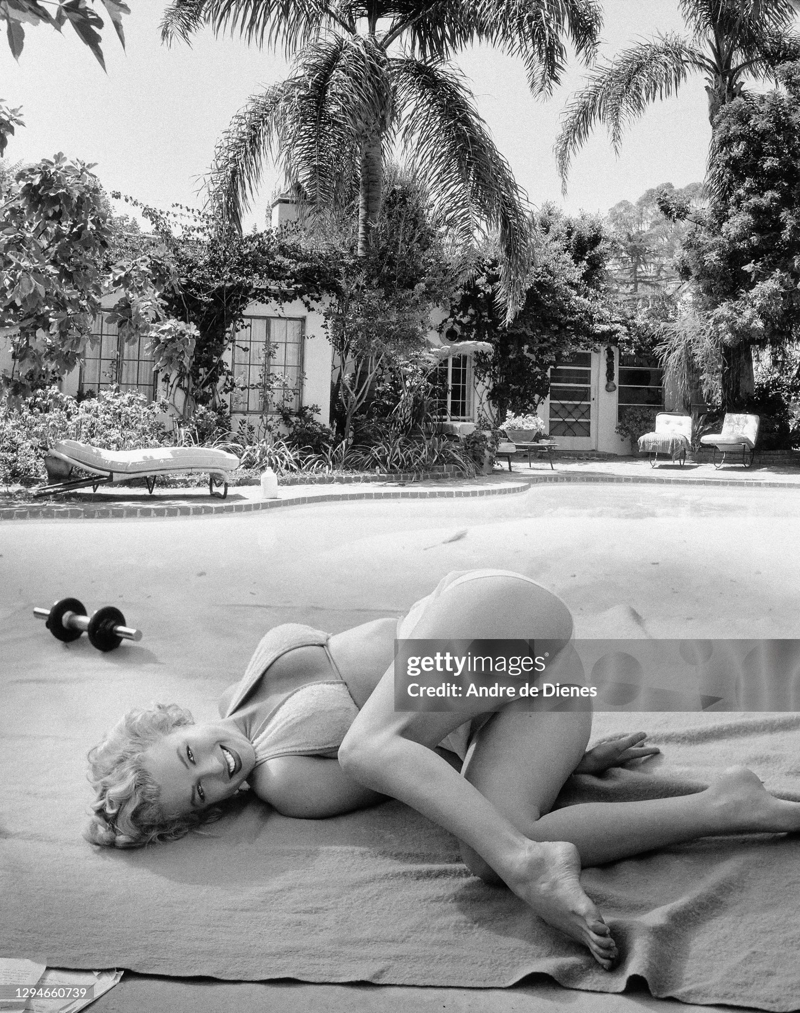 Marilyn Monroe performs stretching exercises outdoors at the Hotel Bel-Air, Los Angeles, California, in 1953. 