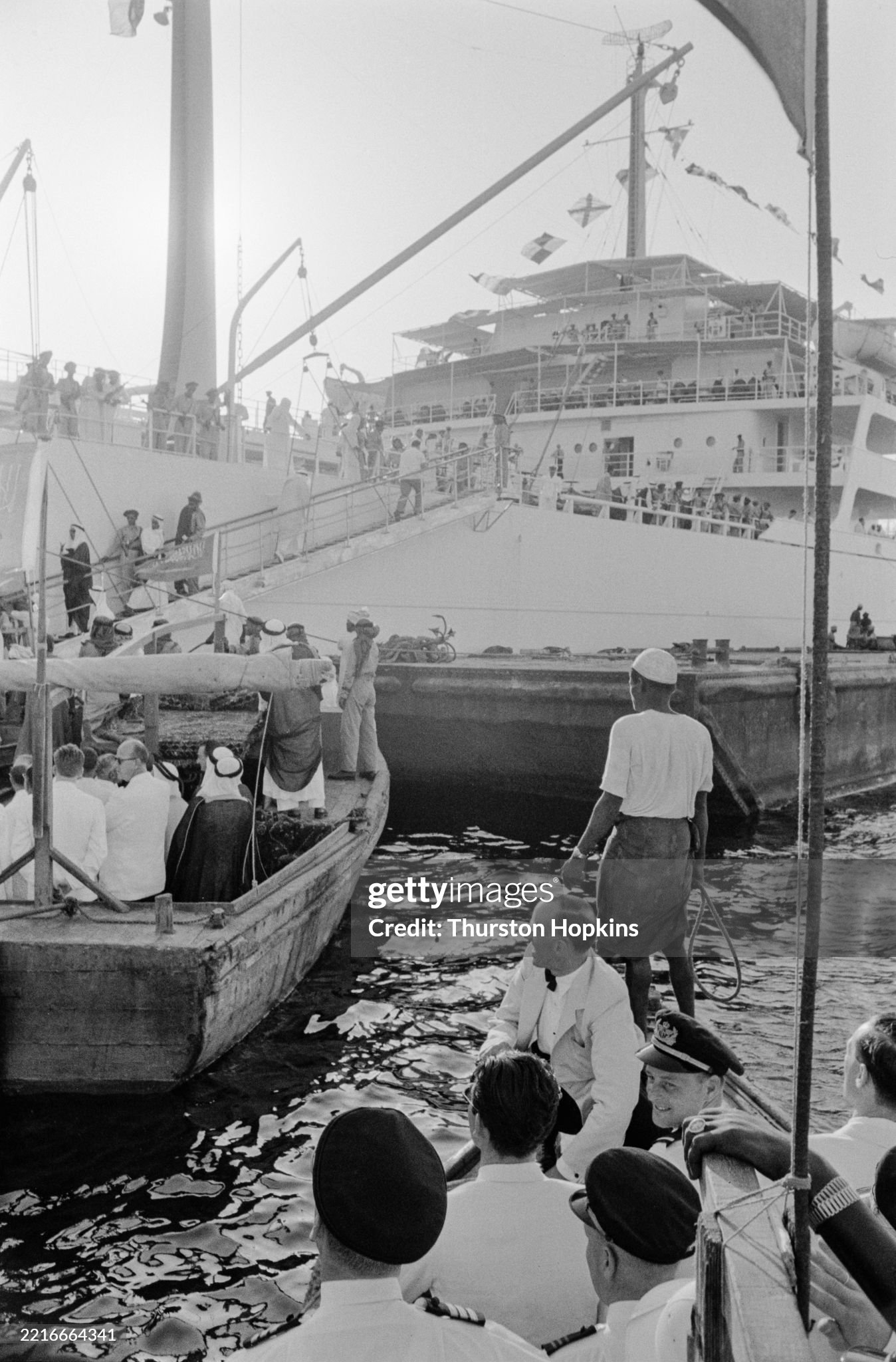 Guests arriving in small boats to board the Al-Malik Saud Al-Awal oil tanker for a party hosted by Aristotle Onassis off the coast of Saudi Arabia in July 1955. 