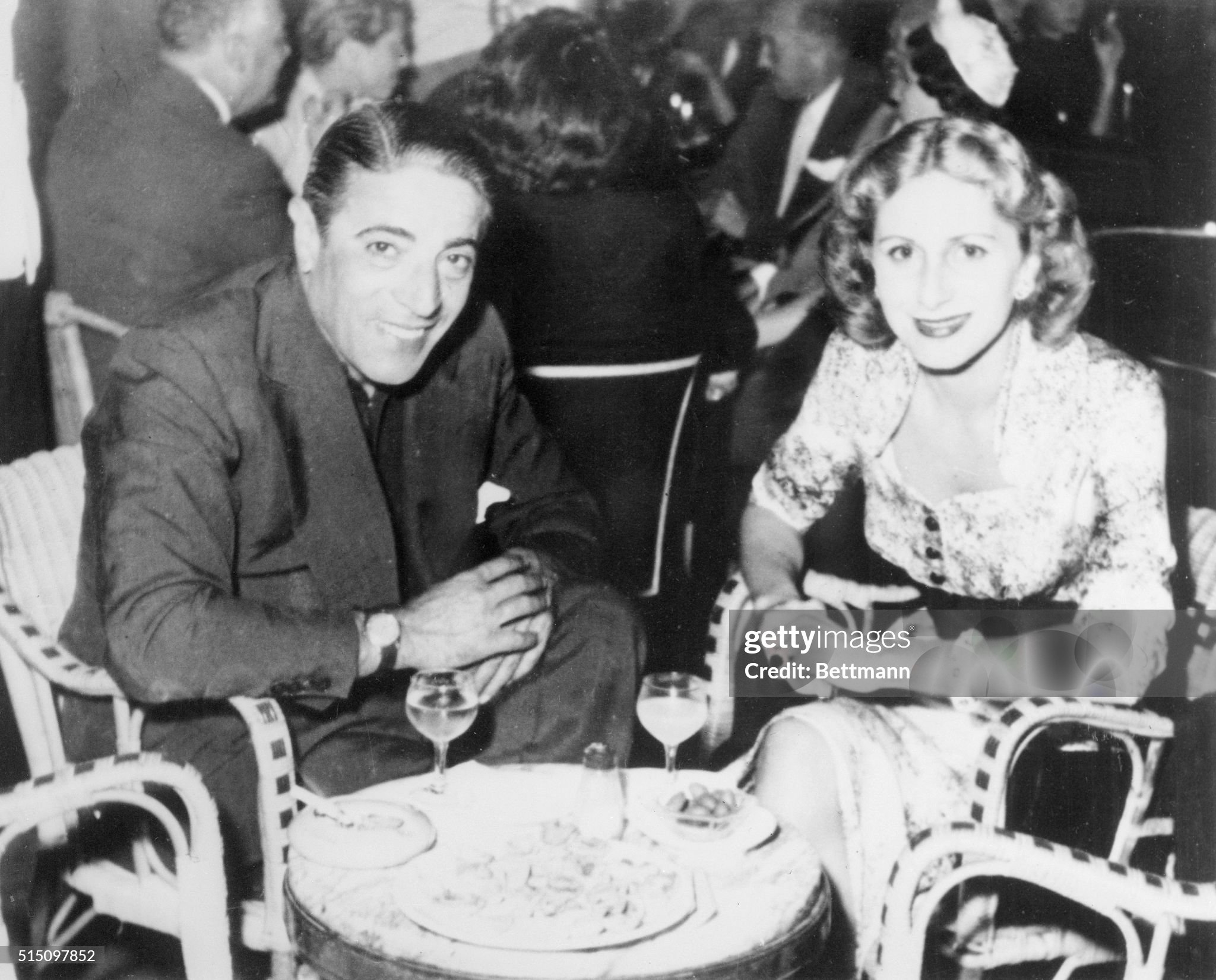 Aristotle Onassis sits with his first wife Athina at an Athens café on September 01, 1955. 