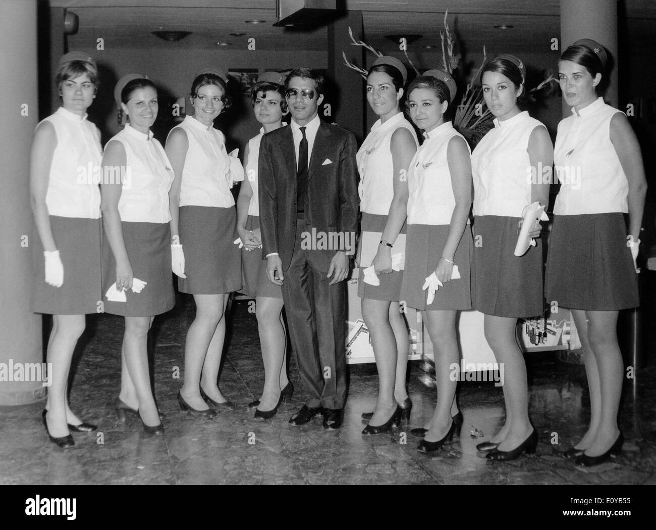 Alexander Onassis with Olympic Airways flight attendants.