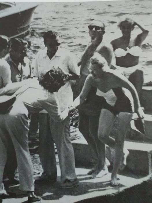 Greta Garbo, in a group that includes Onassis and George Schlee, greeting Gracie Fields during a journey in Capri on the yacht ‘Christina’.