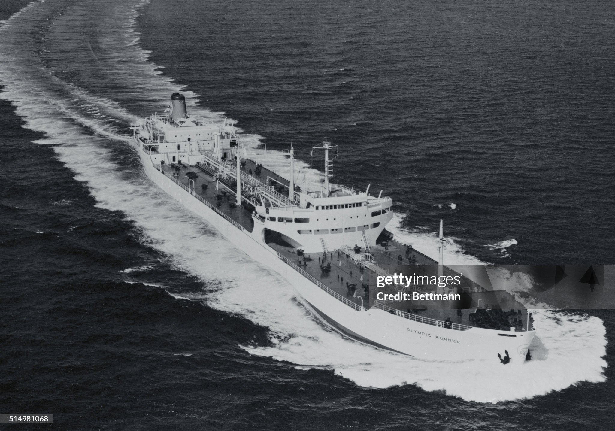 The 23,280 ton tanker, Olympic Runner, leaves a long wake as she is shown cruising here. The ship was constructed at the Yokohama Yards of the Mitsubishi Nippon Heavy Industries, Ltd. She was handed over to her owner, the Luxor Shipping Company, a subsidiary of the Aristotle Socrates Onassis Company, on November 16th 1959. The tanker has a maximum speed of 17.92 knots. 