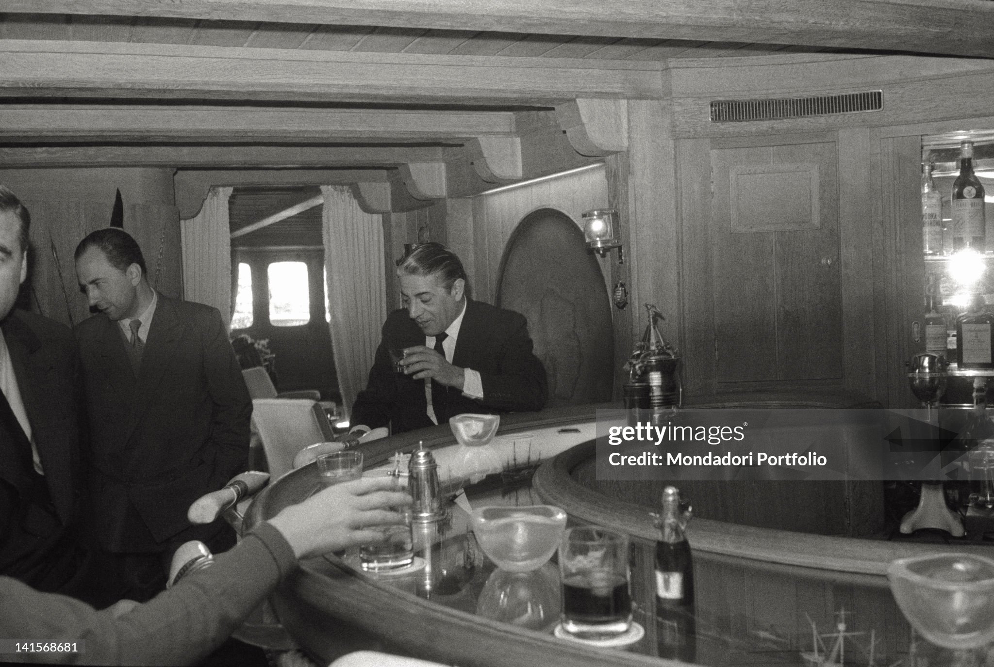 Aristotle Onassis photographed to the circular counter of his yacht 'Christina’ in June 1961. 