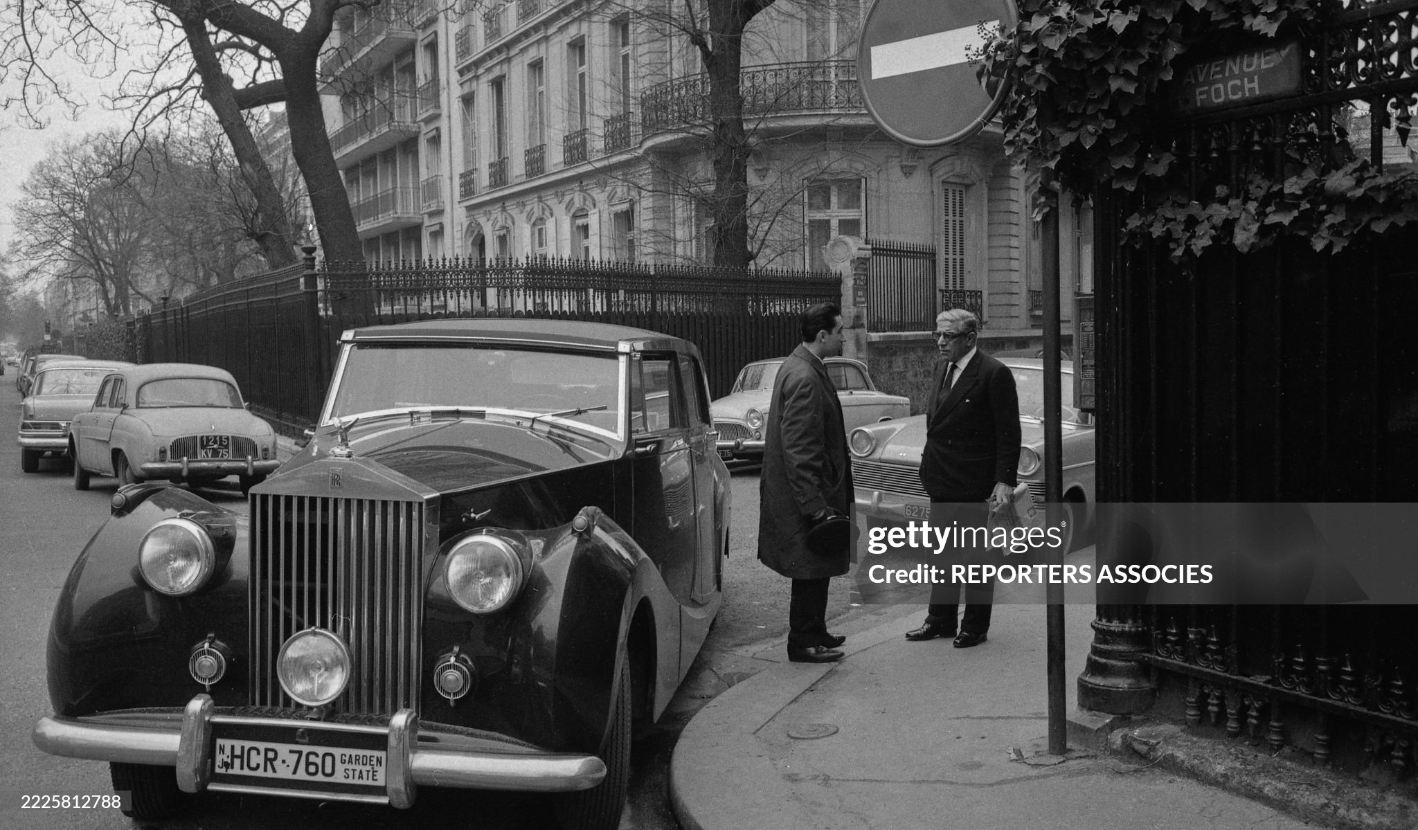 Aristotle Onassis next to his Rolls-Royce Silver Dawn on the street in Paris in 1964. 