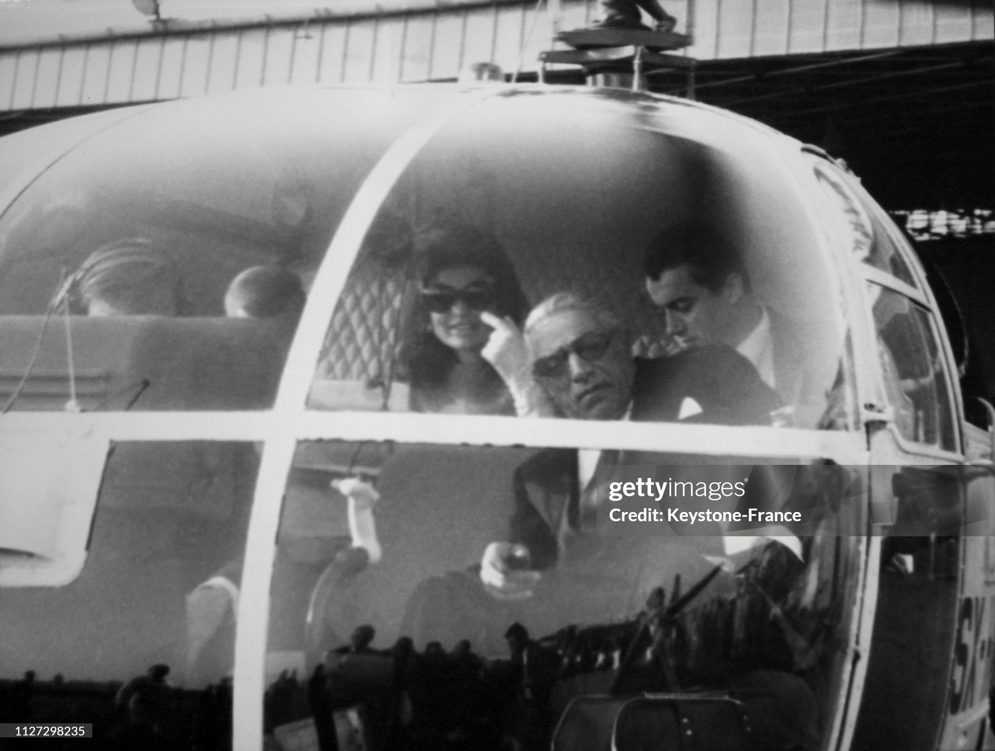 Aristotle Onassis and Jackie Kennedy photographed in a helicopter taking them on their honeymoon, departing from Athens Airport, Greece, on 01 November 1968. 