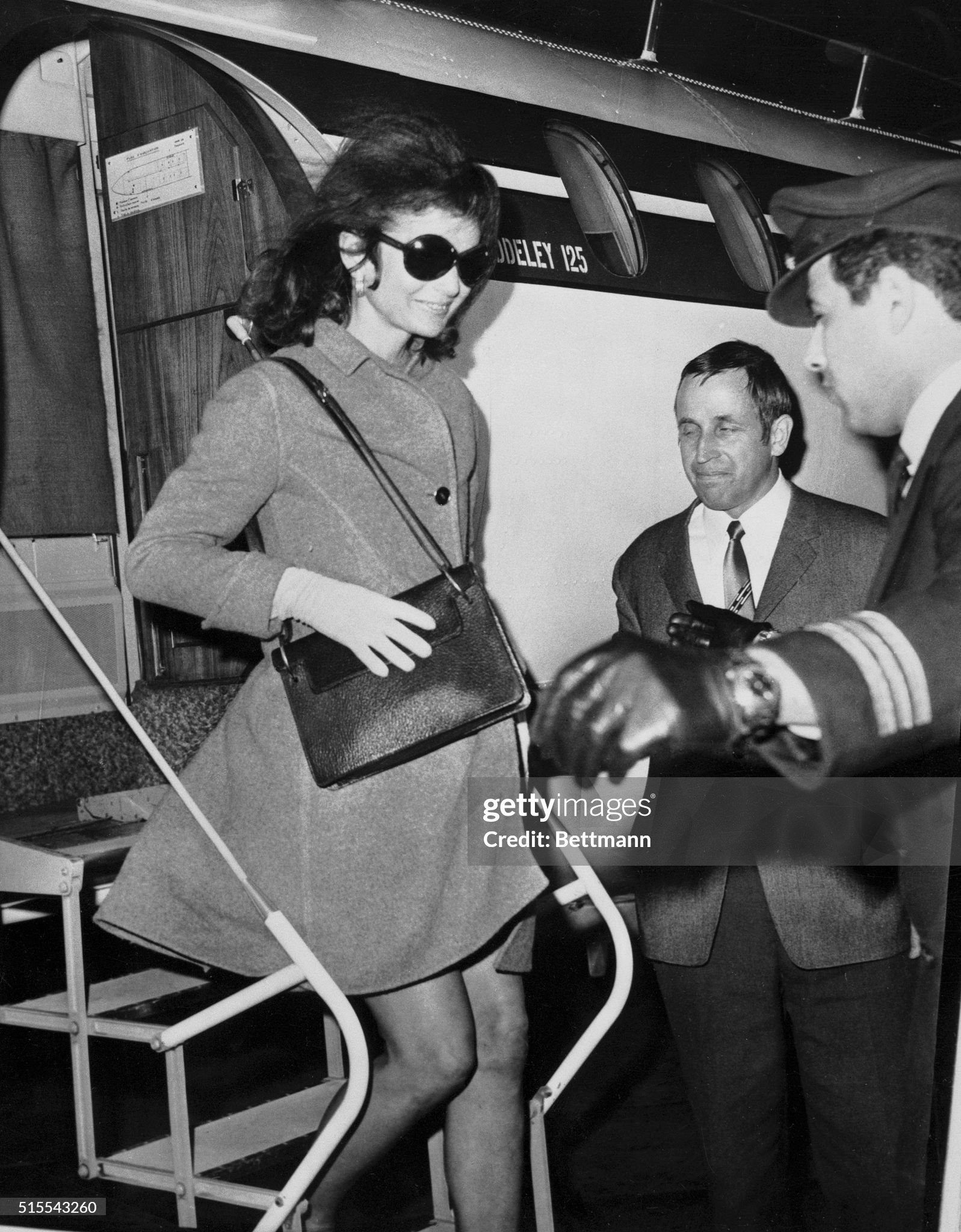 Jacqueline Onassis steps briskly as she leaves a chartered jet here on 14 November on her first visit outside Greece since her wedding. Jackie and her husband, Greek shipping tycoon Aristotle Onassis, are reported to be enroute to the U.S.