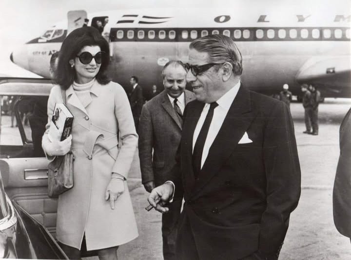 Jackie O' holding the book ‘Gandhi's truth’ by Erik H. Erikson, casually chatting with Onassis after her arrival in Athens from JFK, onboard the aircraft City of Athens B707-384C in 1969.