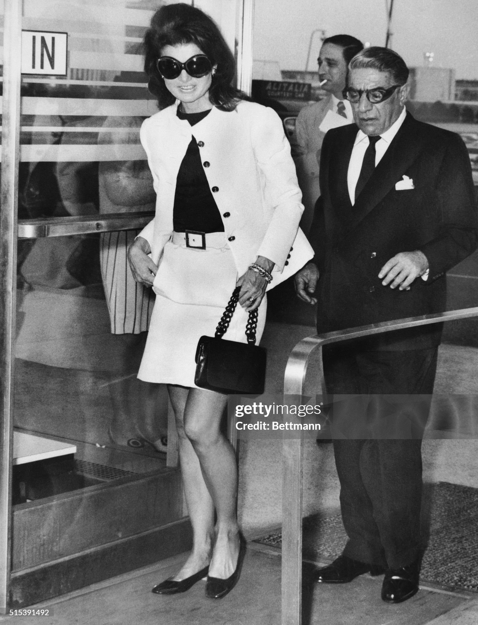 Wearing mod sunglasses and a miniskirt, Jacqueline Kennedy Onassis accompanies her husband, Aristotle, to a plane at Kennedy Airport on today, before the Greek shipping magnate took off for Athens. Ari was flying his own Olympic Airways to Europe and Jackie came along to the airport to say goodbye on 05 June 1969. 