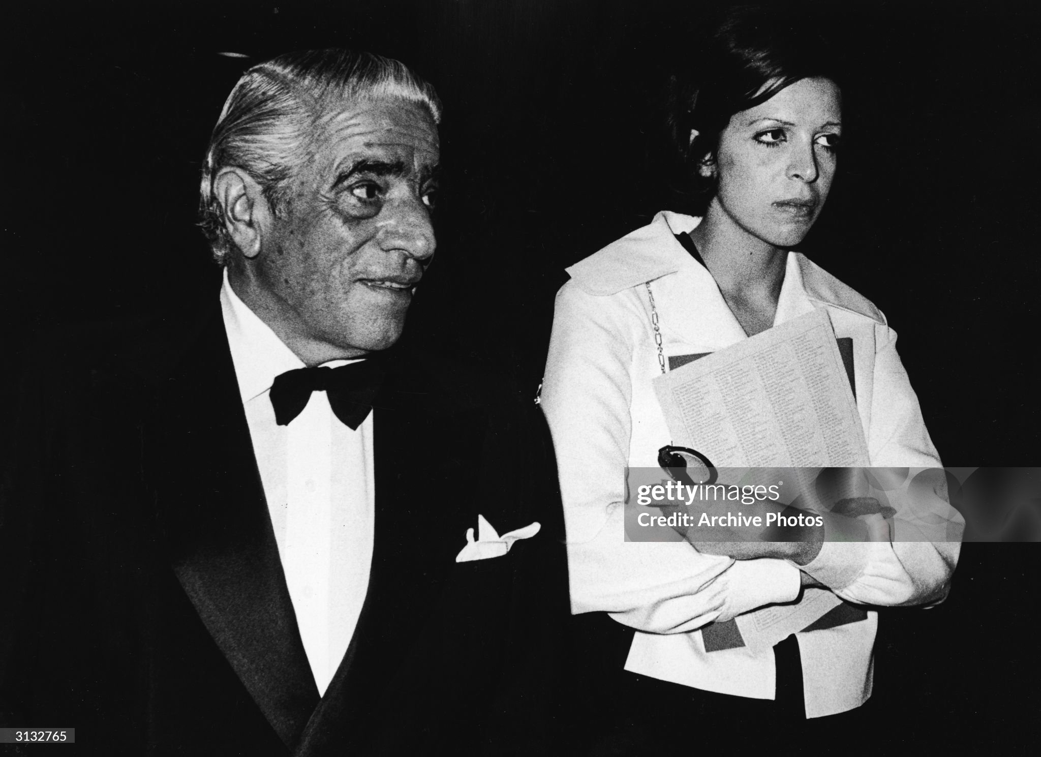 Aristotle Onassis and his daughter, American-born shipping heiress Christina Onassis, walk together as they attend an unidentified formal event in 1970s. 