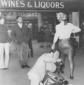 Jackie Onassis emerging from ‘I am curious yellow’ adult film passing a paparazzo who claimed she karate-chopped him to the ground. 