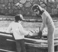 Jackie Onassis and her son photographed from a relatively close distance on Skorpios. 