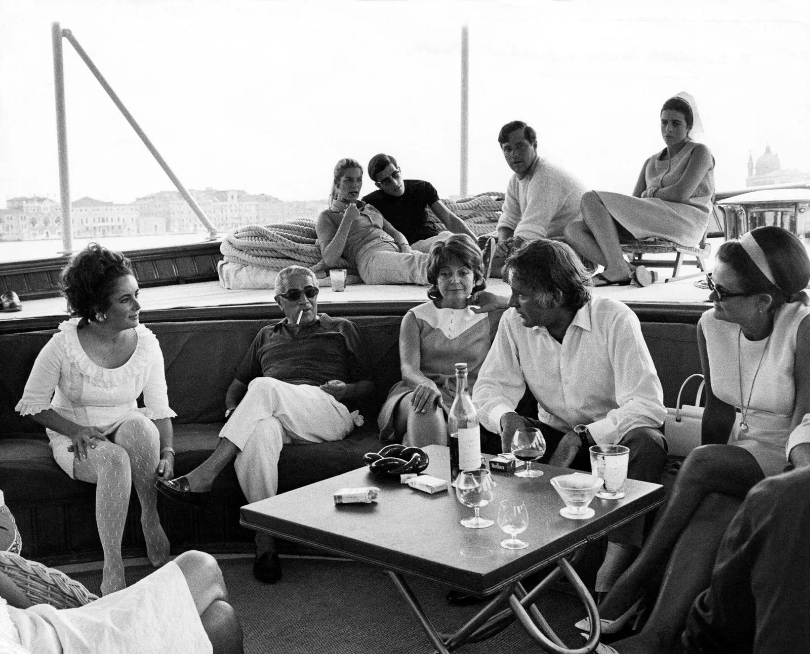 Elizabeth Taylor and Richard Burton visit Aristotle Onassis and his son Alexander (in the background) on board the ‘Christina’ in 1975. 
