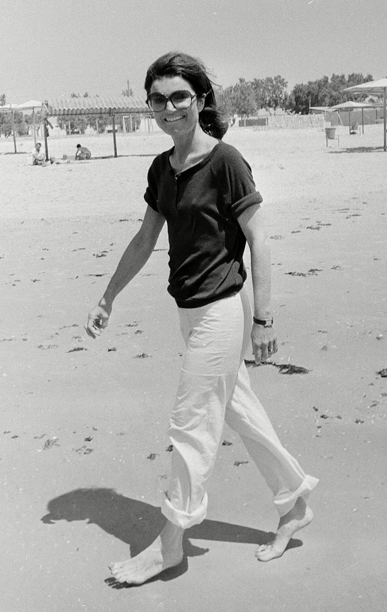 Jacqueline Kennedy Onassis walks barefoot on the beach of Hof Dor, 50 miles north of Tel Aviv, during her first day in Israel on 15 May 1978. 