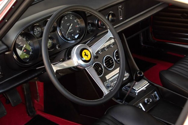 The interior of the car is very well laid out, with black leather upholstery, rich red carpeting, plenty of chrome work, an A/C, push button stereo and, of course, a gated shifter.