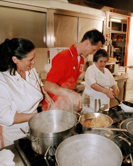 Grandma Dina and mother Rossella teach Michael Schumacher how to make tagliatelle at Montana restaurant in 2000.