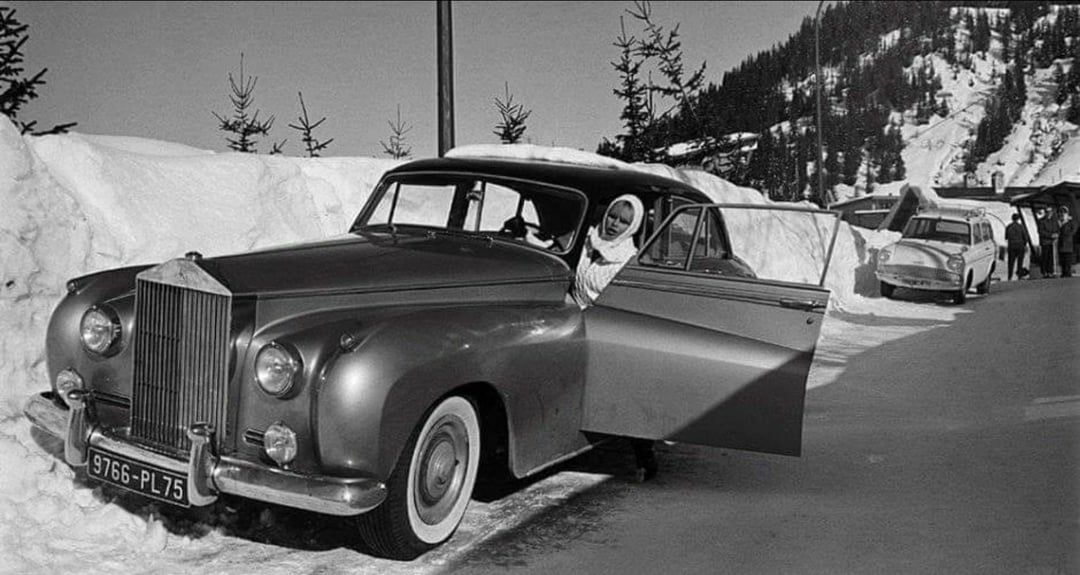 French actress Brigitte Bardot with her 1962 Rolls Royce Silver Cloud II by H.J. Mulliner en route to her vacation home in the French Alps in 1966.