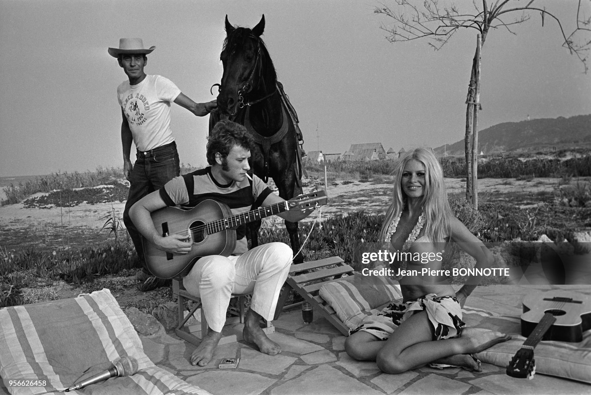Brigitte Bardot and Johnny Hallyday playing guitar on a beach in August 1967 in Saint-Tropez, France.