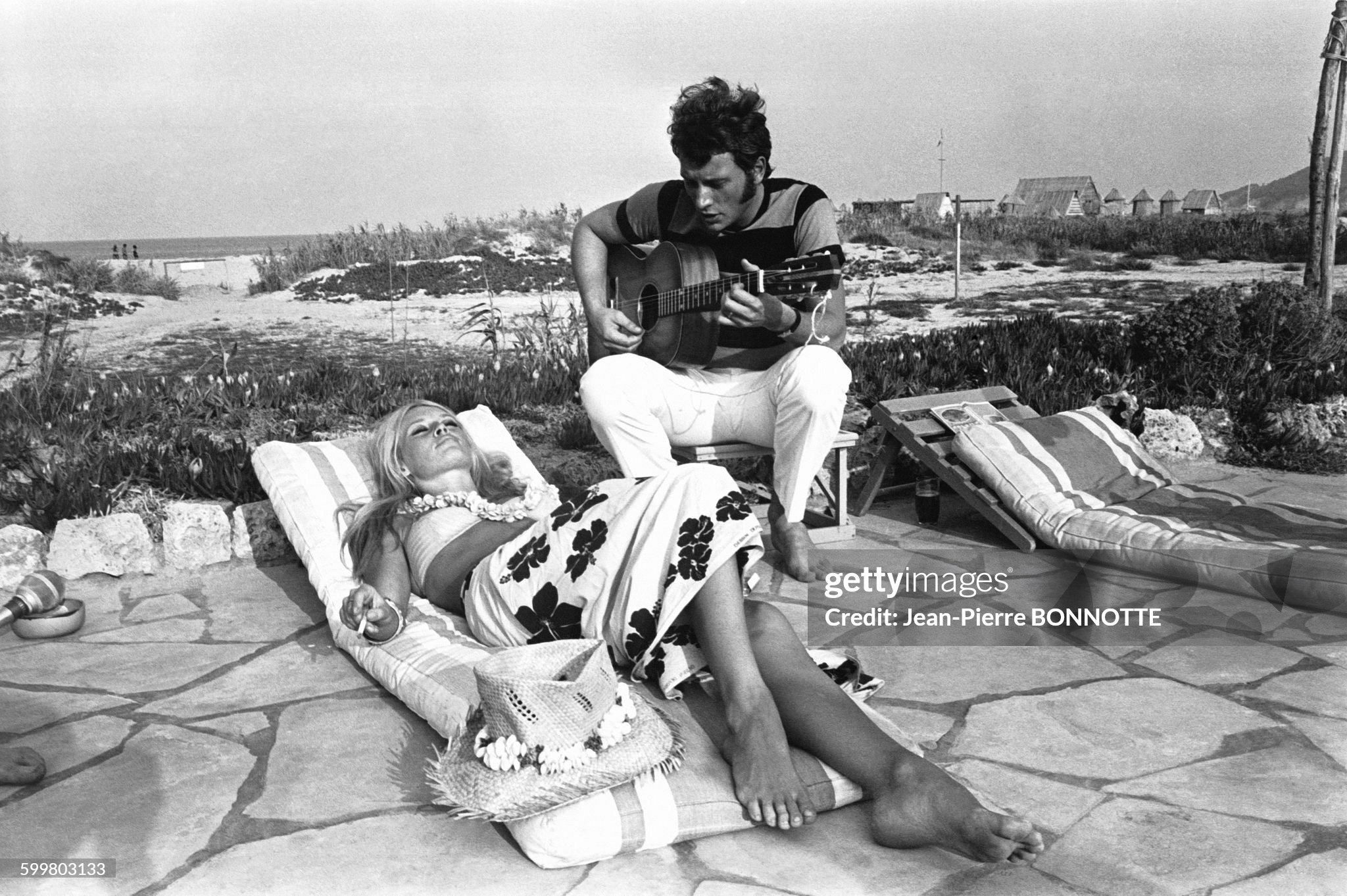 Brigitte Bardot and Johnny Hallyday playing guitar on a beach in August 1967 in Saint-Tropez, France. 