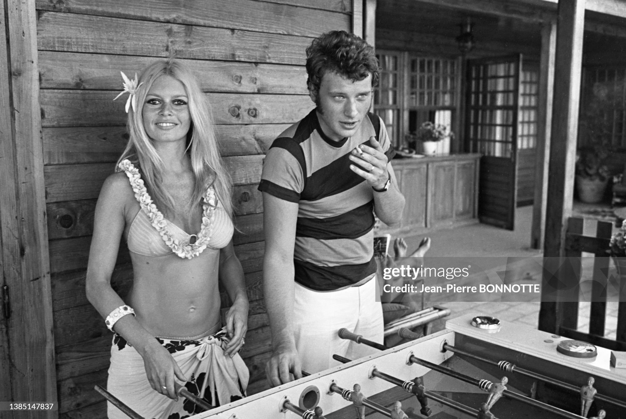Brigitte Bardot in a bikini and sarong and Johnny Hallyday playing foosball at the Epi Plage hotel in Saint-Tropez in August 1967. 