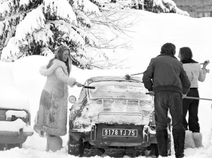 Brigitte Bardot clearing the snow from her Porsche 911 in Megève, France, in 1975.