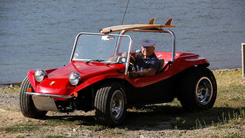 Bruce Meyers in a red Dune Buggy.