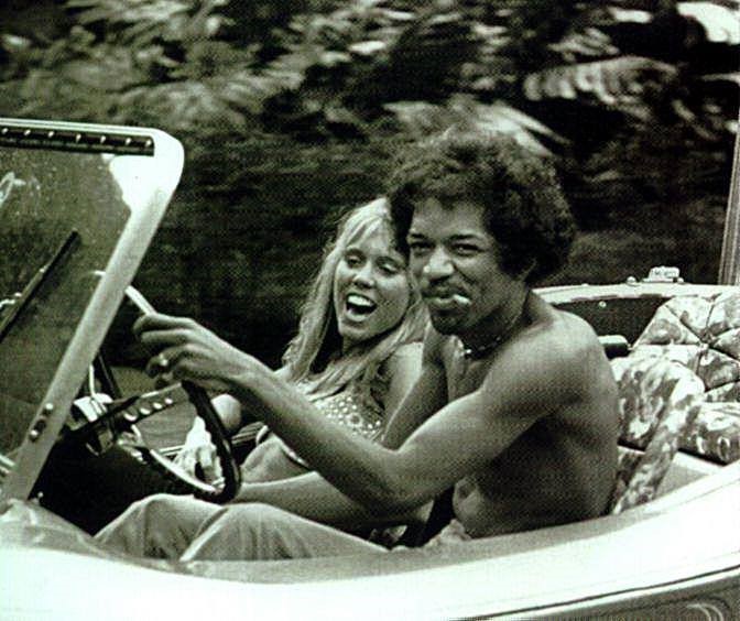 Jimi Hendrix in a Dune Buggy with a girl.