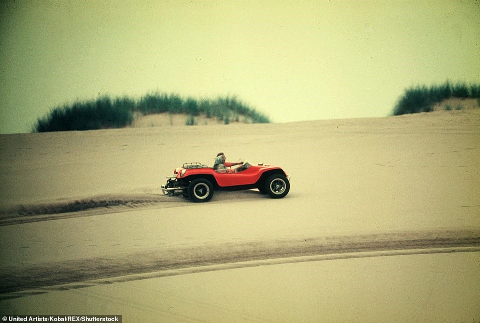 Faye Dunaway and Steve McQueen in an orange Dune Buggy in the movie 'The Thomas Crown Affair'.