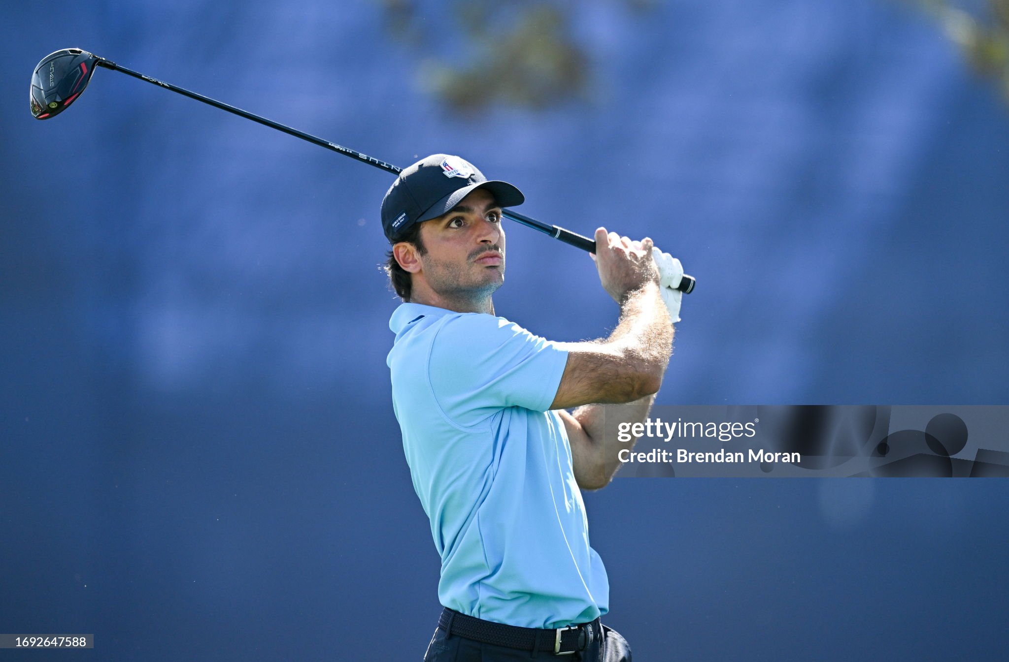 Carlos Sainz watches his tee shot on the 14th hole during the All-Star Match before the 2023 Ryder Cup at Marco Simone Golf and Country Club in Rome. 