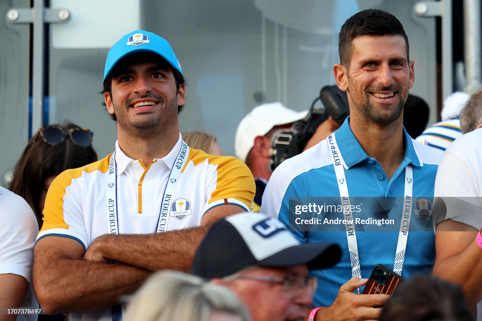 Formula 1 driver Carlos Sainz and tennis player Novak Djokovic watch at the first tee during the Friday morning foursomes matches of the 2023 Ryder Cup at Marco Simone Golf Club on September 29, 2023 in Rome, Italy. 