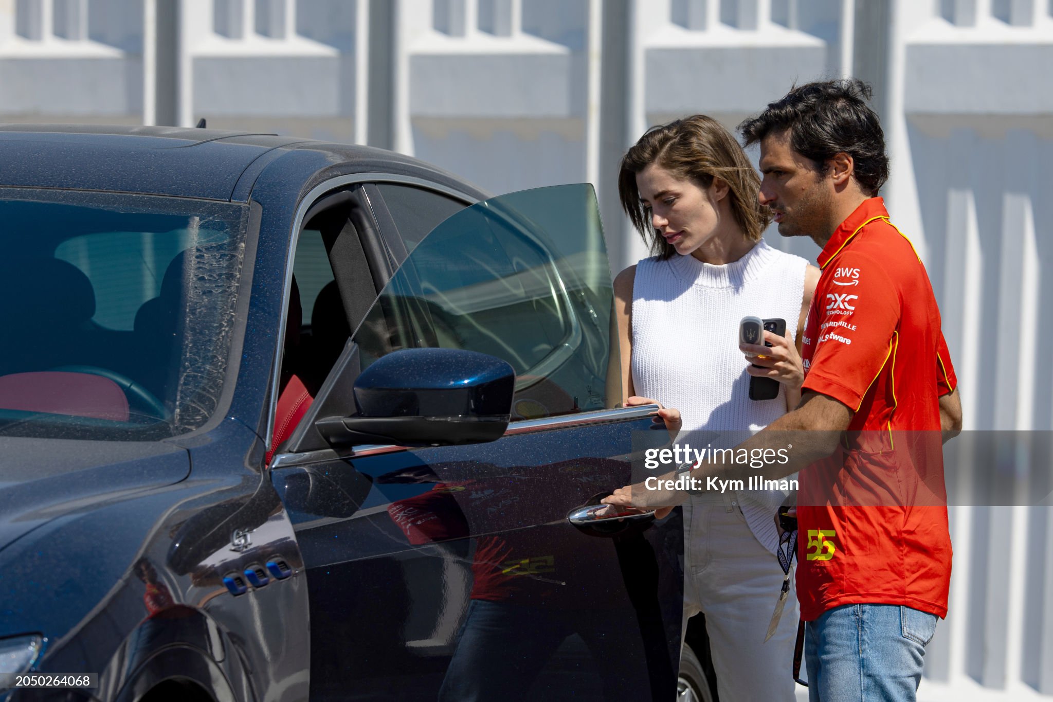 Carlos Sainz and girlfriend Rebecca Donaldson arrive together during qualifying ahead of the F1 Grand Prix of Bahrain at Bahrain International Circuit on March 01, 2024. 