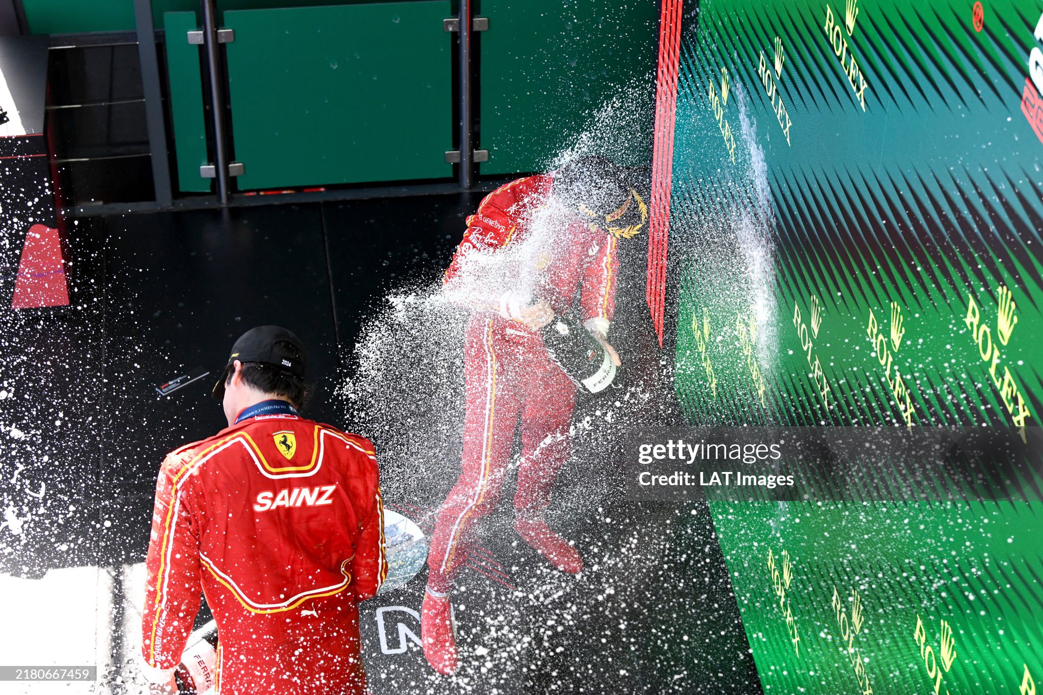 Carlos Sainz and Charles Leclerc spray champagne on the podium after the Australian GP at Melbourne Grand Prix Circuit on Sunday March 24, 2024. 