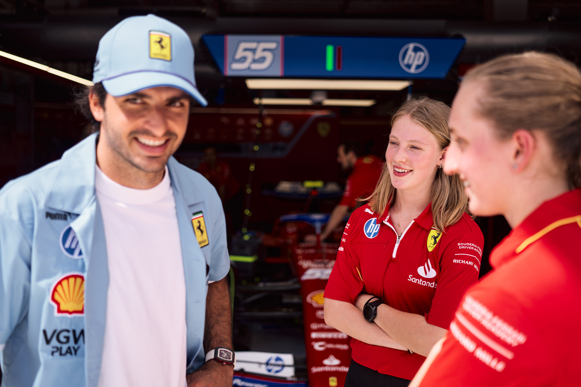 Carlos Sainz with Ferrari F1 Academy female drivers Maya Weug and Aurelia Nobels before heading out on track at the Miami Grand Prix on May 04, 2024.