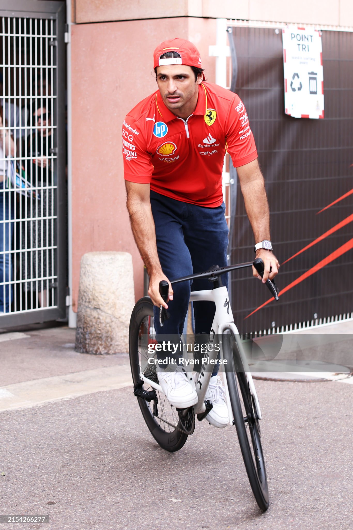 Carlos Sainz of Spain and Ferrari rides a bicycle in the paddock during previews ahead of the F1 Grand Prix of Monaco at Circuit de Monaco on May 23, 2024 in Monte-Carlo, Monaco.