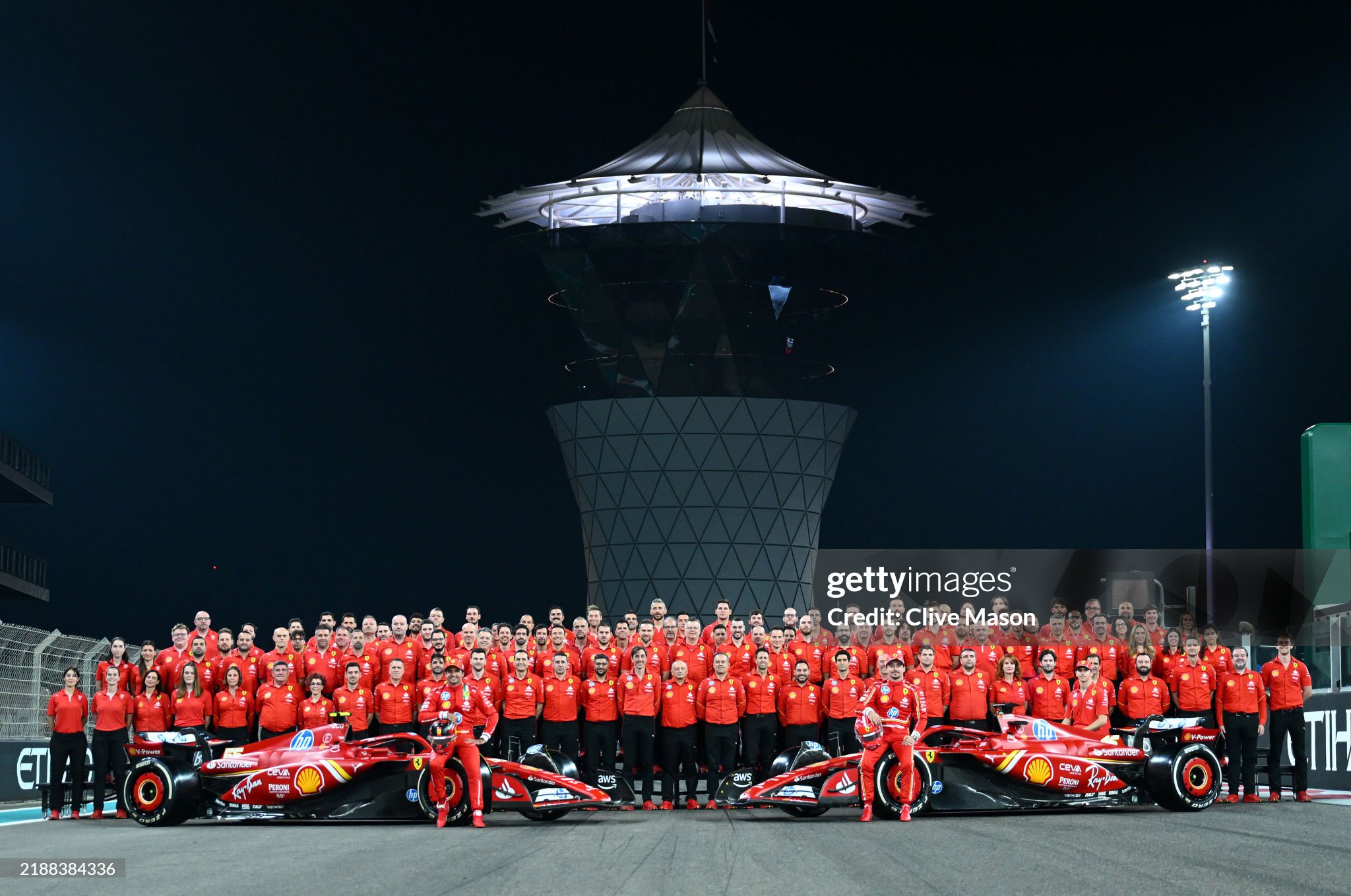 Charles Leclerc, Carlos Sainz and the Ferrari team pose for a photo on track during previews ahead of the F1 Grand Prix of Abu Dhabi on December 05, 2024.